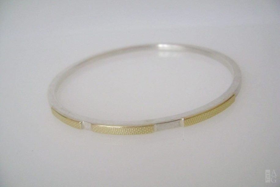 Sterling silver and 14kt. gold, hand-crafted Bangle by Andrea Roberts at The Avenue Gallery, a contemporary fine art gallery in Victoria, BC, Canada.
