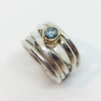 Sterling Silver OneFooter Ring with Blue Zircon set in 18kt. Yellow Gold by Dorothée Rosen at The Avenue Gallery, a contemporary fine art gallery in Victoria, BC, Canada.
