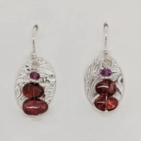 Small Textured Oval Earrings with Garnets by Veronica Stewart at The Avenue Gallery, a contemporary fine art gallery in Victoria, BC, Canada.