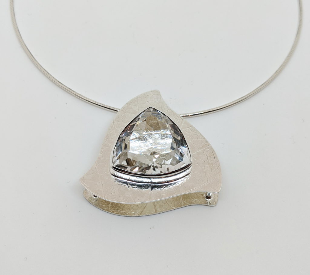 Natural Quartz (trillion cut) cage setting 53.5 carat pendant with magnolia leaf texture by A & R Jewellery at The Avenue Gallery, a contemporary fine art gallery in Victoria, BC, Canada.