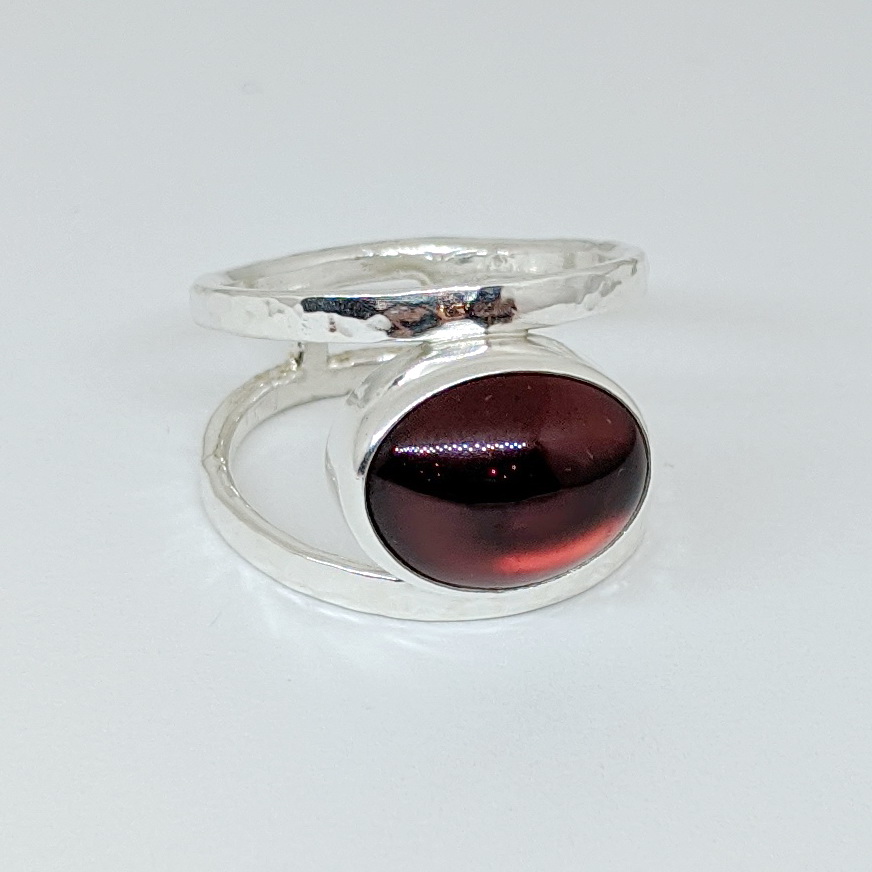 Round Band Ring with Garnet by A & R Jewellery at The Avenue Gallery, a contemporary fine art gallery in Victoria, BC, Canada.