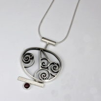 Spiral Pendant with Garnet by Brenda Roy at The Avenue Gallery, a contemporary art gallery in Victoria BC., Canada