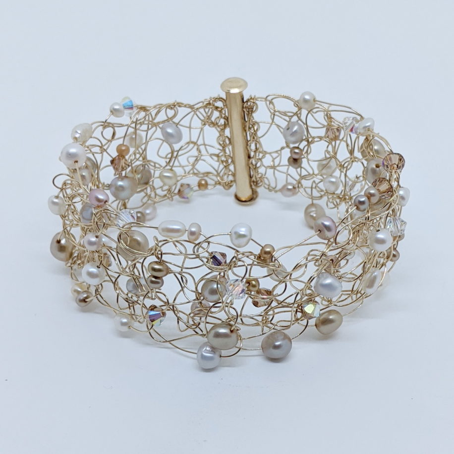 Gold Filled Crochet Wire Cuff with Freshwater Pearls and Swarovski Crystals by Veronica Stewart at The Avenue Gallery, a contemporary fine art gallery in Victoria, BC, Canada.