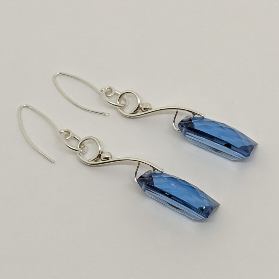 Wave Dangle Earrings with London Blue Topaz by A & R Jewellery at The Avenue Gallery, a contemporary fine art gallery in Victoria, BC, Canada.