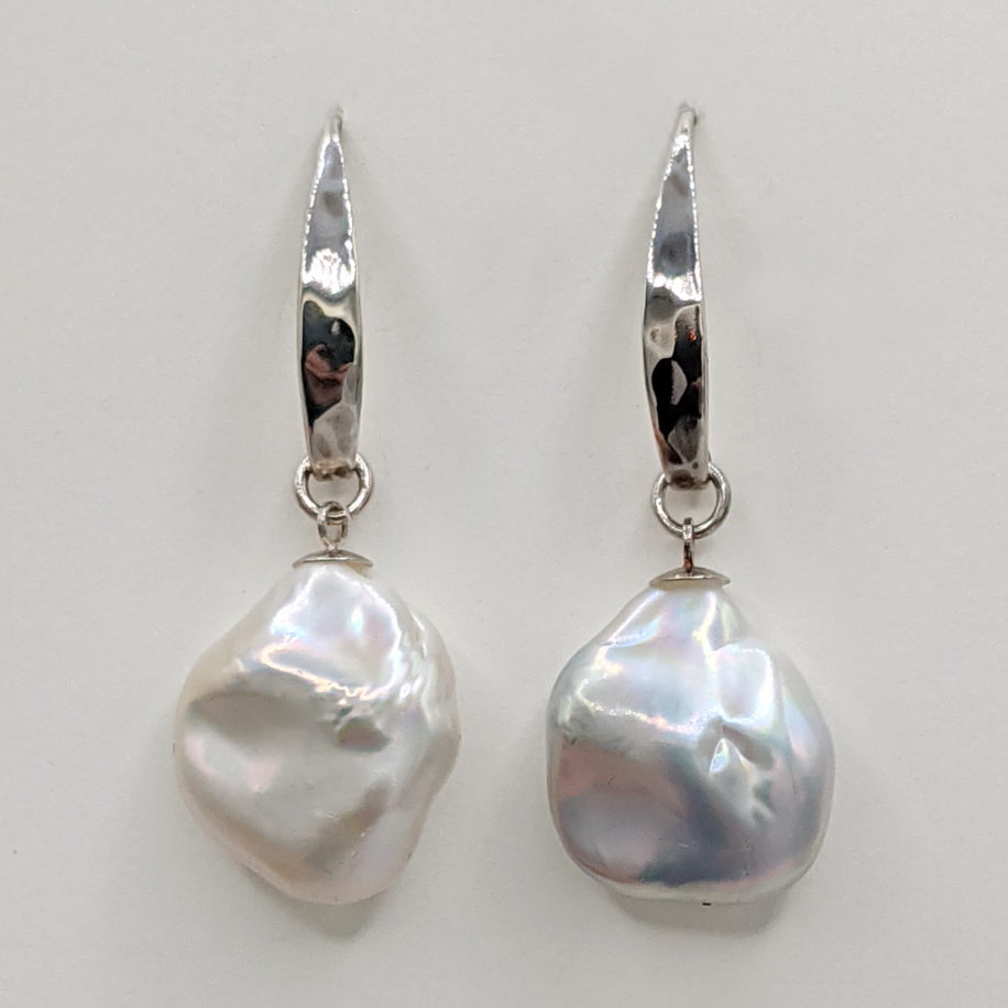 White Baroque Pearl Earrings on Hammered Long Sterling Silver Wires by Val Nunns at The Avenue Gallery, a contemporary fine art gallery in Victoria, BC, Canada.