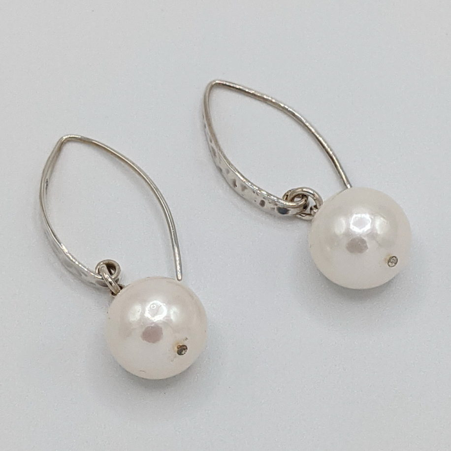 White Shell Pearl Earrings on Hammered Sterling Silver Wires by Val Nunns at The Avenue Gallery, a contemporary fine art gallery in Victoria, BC, Canada.