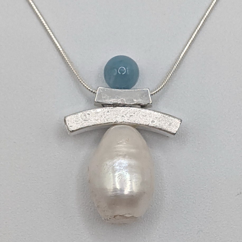 Balance Inukshuk Necklace with Aquamarine & White Pearl by Chi's Creations at The Avenue Gallery, a contemporary fine art gallery in Victoria, BC, Canada.