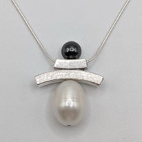 Balance Inukshuk Necklace with Hematite & White Pearl by Chi's Creations at The Avenue Gallery, a contemporary fine art gallery in Victoria, BC, Canada.