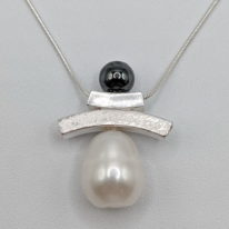 Balance Inukshuk Necklace with Hematite & White Pearl by Chi's Creations at The Avenue Gallery, a contemporary fine art gallery in Victoria, BC, Canada.