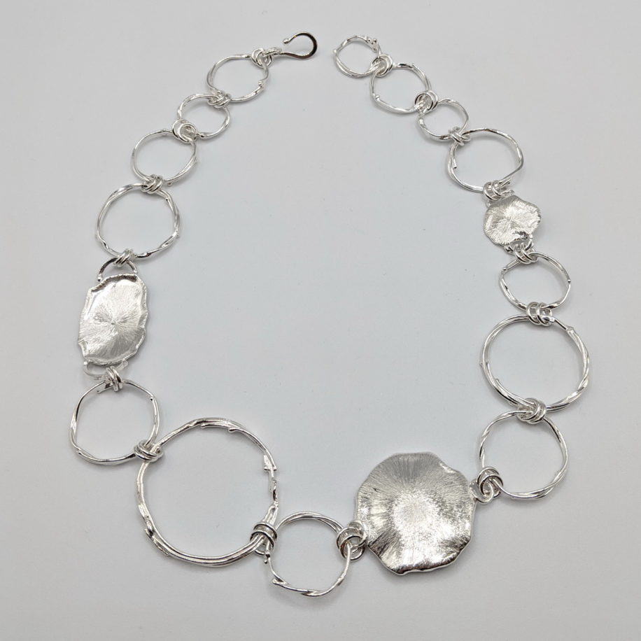 Hollow Boulders with Suns Linked Necklace by A & R Jewellery at The Avenue Gallery, a contemporary fine art gallery in Victoria, BC, Canada.