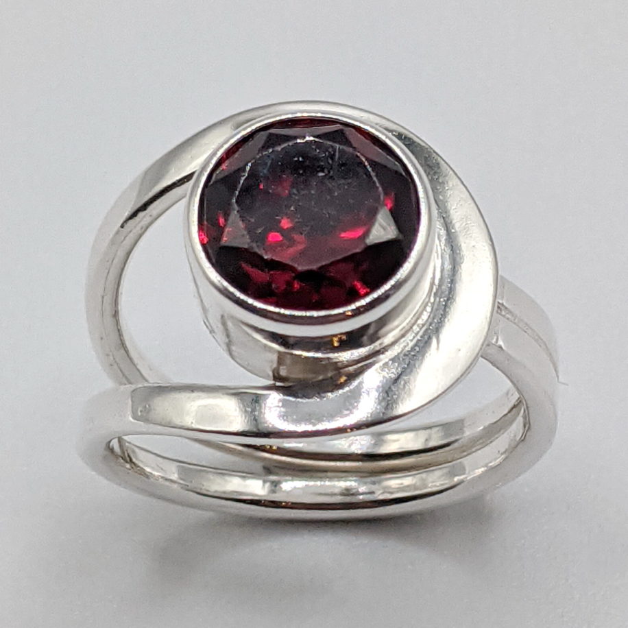 Buttonhole Ring with Garnet by A & R Jewellery at The Avenue Gallery, a contemporary fine art gallery in Victoria, BC, Canada.