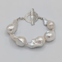 White Baroque Freshwater Pearl Bracelet with Hammered Sterling Silver Toggle Clasp by Val Nunns at The Avenue Gallery, a contemporary fine art gallery in Victoria, BC, Canada.