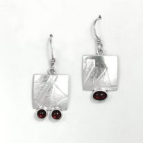 Textured Silver and Garnet Earrings by Brenda Roy at The Avenue Gallery, a contemporary fine art gallery in Victoria, BC, Canada.