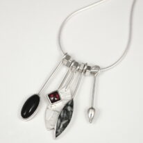 Pinolith, Black Onyx, & Garnet Dangly Necklace by Brenda Roy at The Avenue Gallery, a contemporary fine art gallery in Victoria, BC, Canada.