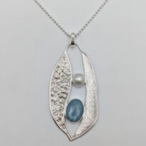 Lunar Pendant with Aquamarine & Pearl by A & R Jewellery at The Avenue Gallery, a contemporary fine art gallery in Victoria, BC, Canada.