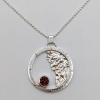 Sun & Moon Pendant with Garnet by A & R Jewellery at The Avenue Gallery, a contemporary fine art gallery in Victoria, BC, Canada.