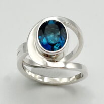 Buttonhole Ring with London Blue Topaz by A & R Jewellery at The Avenue Gallery, a contemporary fine art gallery in Victoria, BC, Canada.