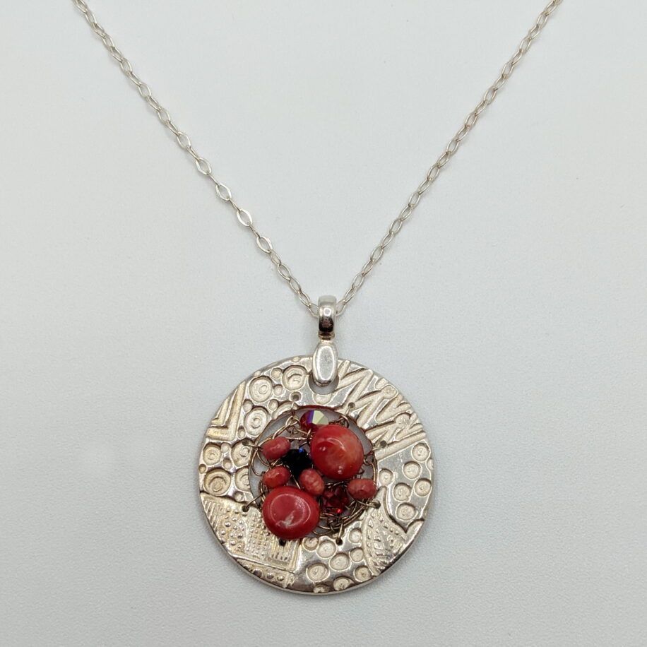 Small Round Textured Pendant with Red Coral & Swarovski Crystals by Veronica Stewart at The Avenue Gallery, a contemporary fine art gallery in Victoria, BC, Canada.