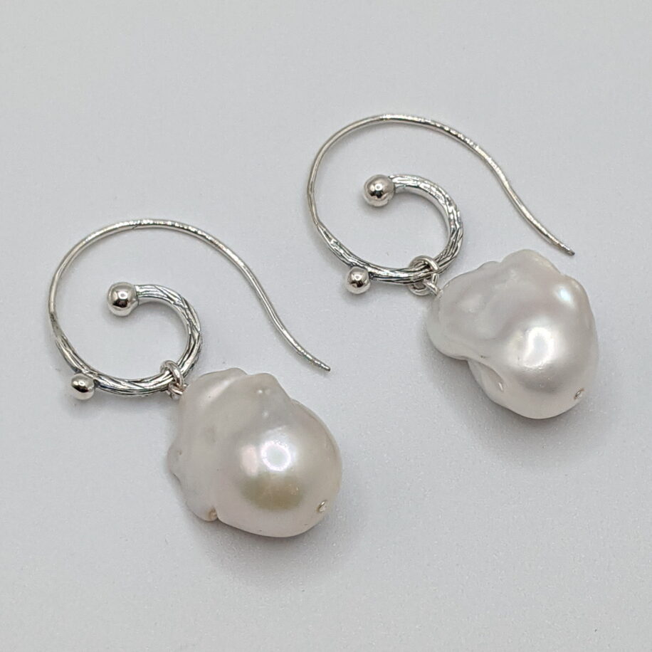 White Baroque Pearl Earrings with Hammered Sterling Silver Curled Wire by Val Nunns at The Avenue Gallery, a contemporary fine art gallery in Victoria, BC, Canada.