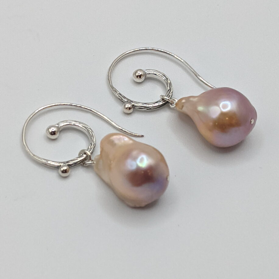 Pink Baroque Pearl Earrings with Hammered Sterling Silver Curled Wire by Val Nunns at The Avenue Gallery, a contemporary fine art gallery in Victoria, BC, Canada.