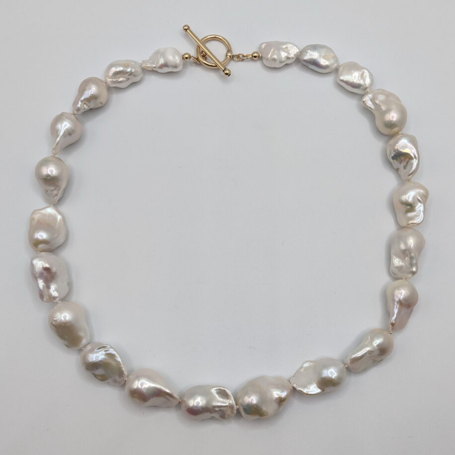 White Baroque Pearl Necklace with Yellow Gold-Plated Toggle Clasp by Val Nunns at The Avenue Gallery, a contemporary fine art gallery in Victoria, BC, Canada.