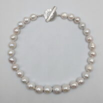 White Fireball Pearl Necklace with Hammered Sterling Silver Toggle Clasp by Val Nunns at The Avenue Gallery, a contemporary fine art gallery in Victoria, BC, Canada.