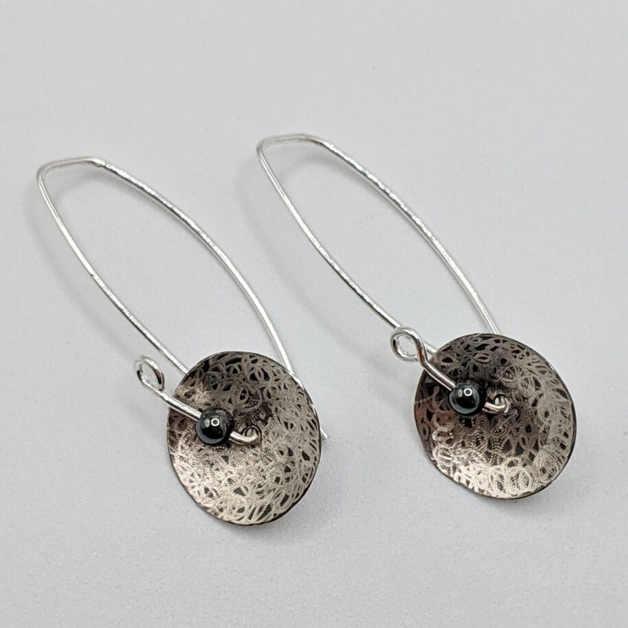 Oxidized Scribbled Disc Earrings with Hematite by Chi's Creations at The Avenue Gallery, a contemporary fine art gallery in Victoria, BC, Canada.