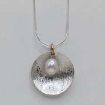 Scribbled Large Concaved Silver Disc Pendant with White Pearl by Chi's Creations at The Avenue Gallery, a contemporary fine art gallery in Victoria, BC, Canada.