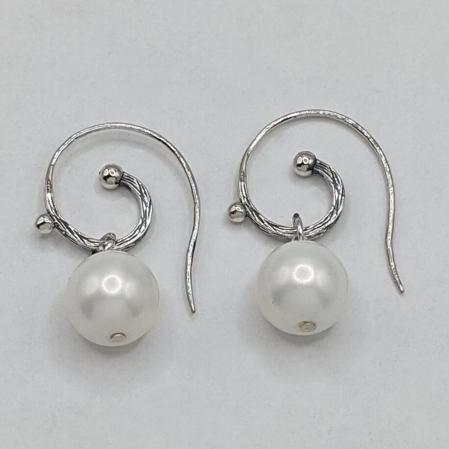 White Shell Pearl Earrings with Sterling Silver Curly Wires by Val Nunns at The Avenue Gallery, a contemporary fine art gallery in Victoria, BC, Canada.