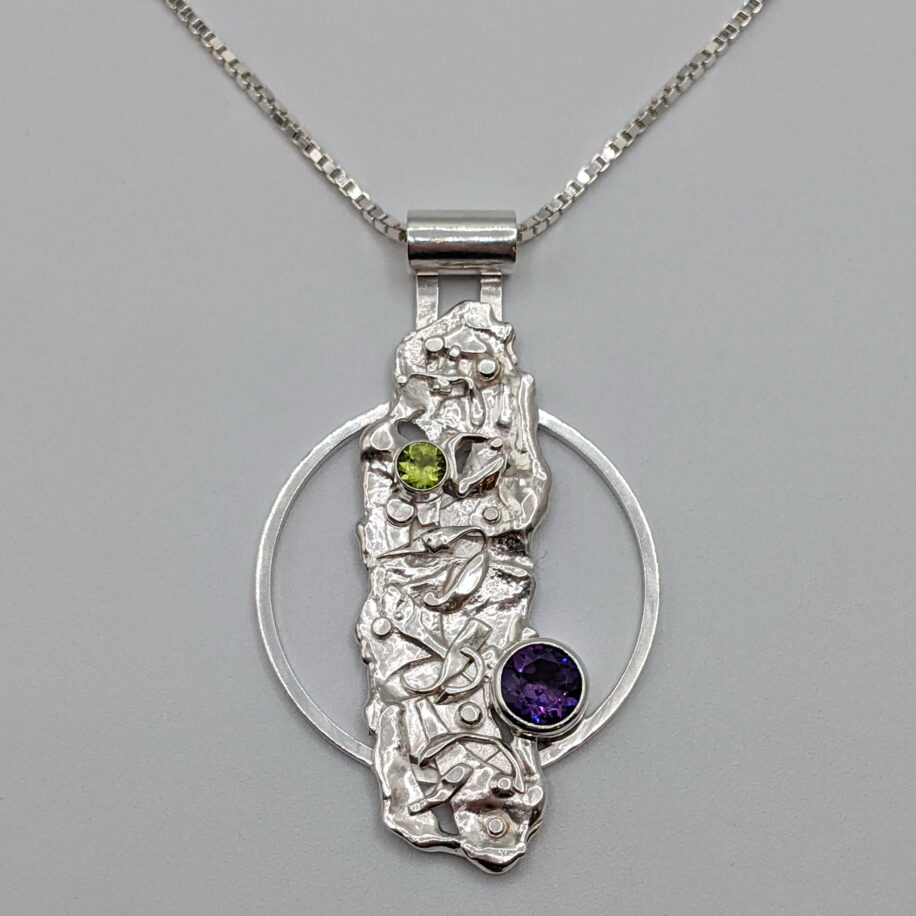 Rapids Circle Pendant with Amethyst & Peridot by A & R Jewellery at The Avenue Gallery, a contemporary fine art gallery in Victoria, BC, Canada.