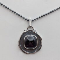 Wax Seal Pendant with Garnet by A & R Jewellery at The Avenue Gallery, a contemporary fine art gallery in Victoria, BC, Canada.