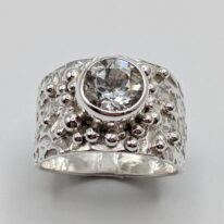 Lunar Granules Band Ring with White Topaz by A & R Jewellery at The Avenue Gallery, a contemporary fine art gallery in Victoria, BC, Canada.