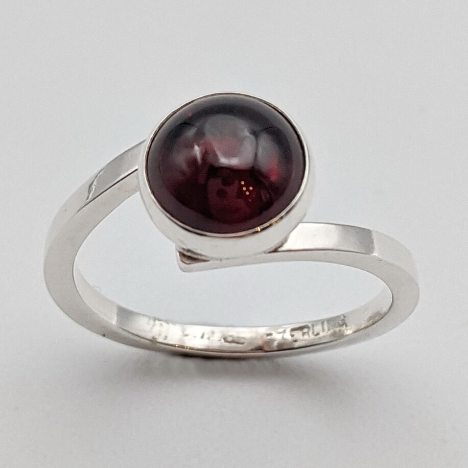 Offset Solitaire Ring with Garnet by A & R Jewellery at The Avenue Gallery, a contemporary fine art gallery in Victoria, BC, Canada.