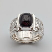 Lunar Band Ring with Garnet by A & R Jewellery at The Avenue Gallery, a contemporary fine art gallery in Victoria, BC, Canada.