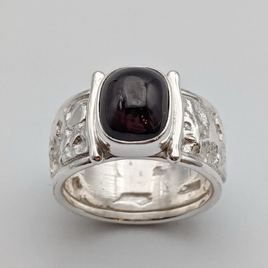 Lunar Band Ring with Garnet by A & R Jewellery at The Avenue Gallery, a contemporary fine art gallery in Victoria, BC, Canada.