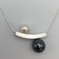 Balanced Yin-Yang Necklace with White Pearl & Hematite by Chi's Creations at The Avenue Gallery, a contemporary fine art gallery in Victoria, BC, Canada.