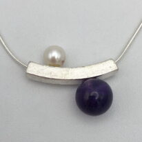 Balanced Yin-Yang Necklace with White Pearl & Amethyst by Chi's Creations at The Avenue Gallery, a contemporary fine art gallery in Victoria, BC, Canada.